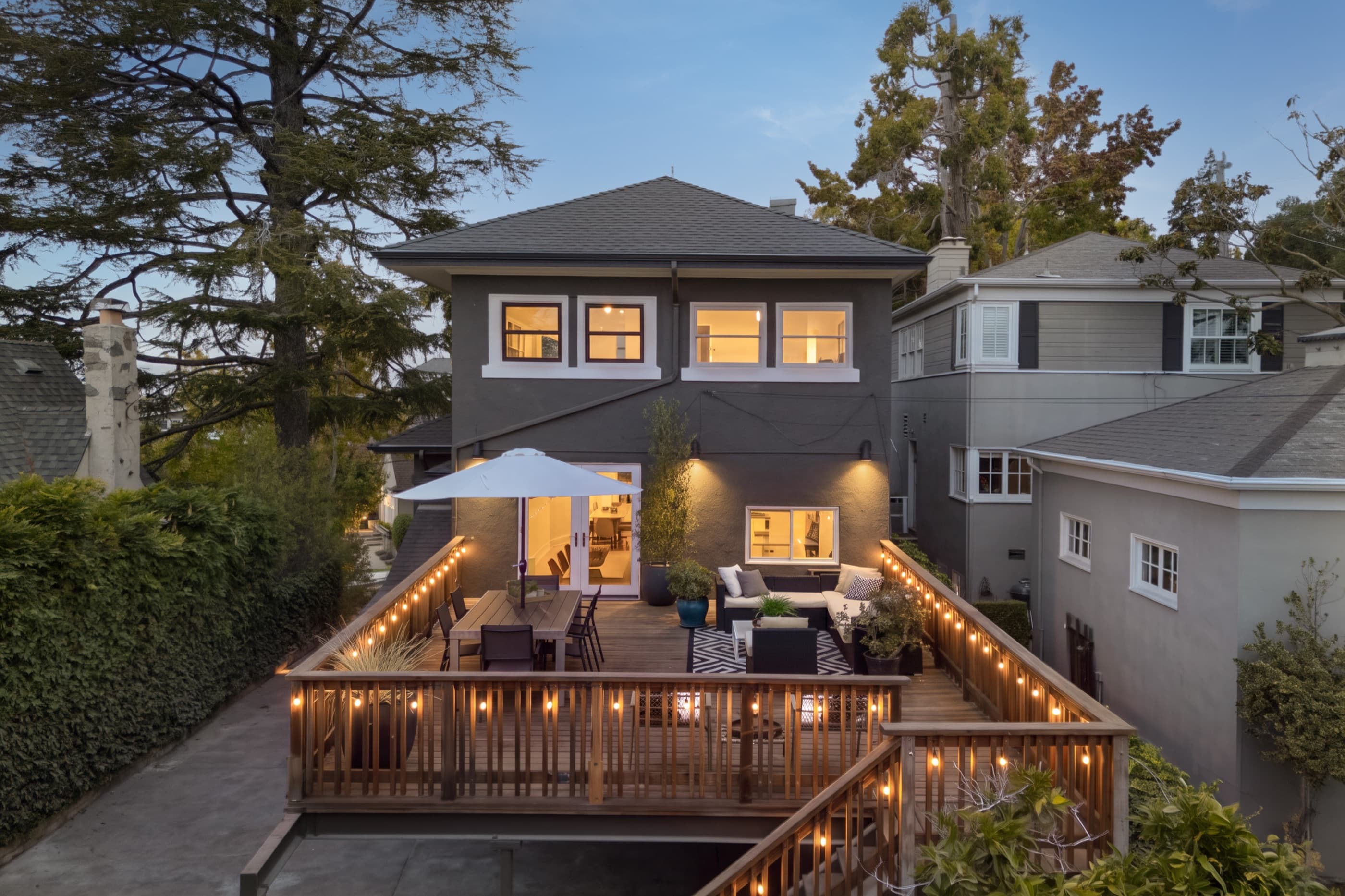 362 Magnolia Avenue at twilight, the deck lit from below.