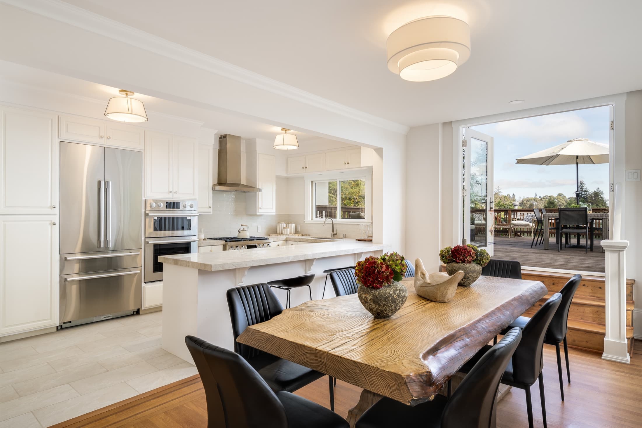 The dining room and kitchen, opening to the deck beyond.
